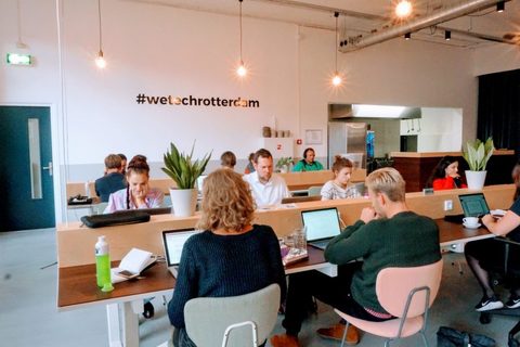 a group of people sitting at a desk in a room