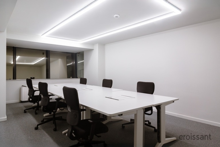 an office with a desk and chair in a room