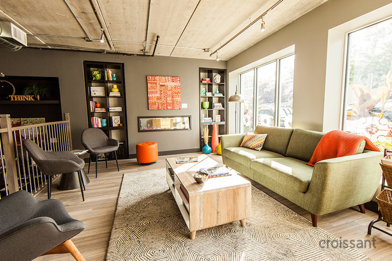 a living room filled with furniture and a large window