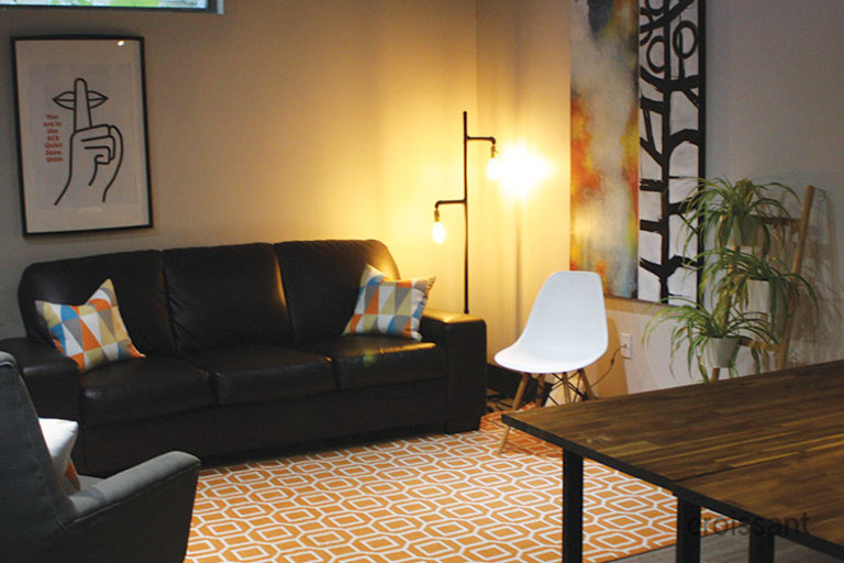 a living room with a couch a table and chairs