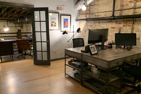 a desk with a laptop in a room