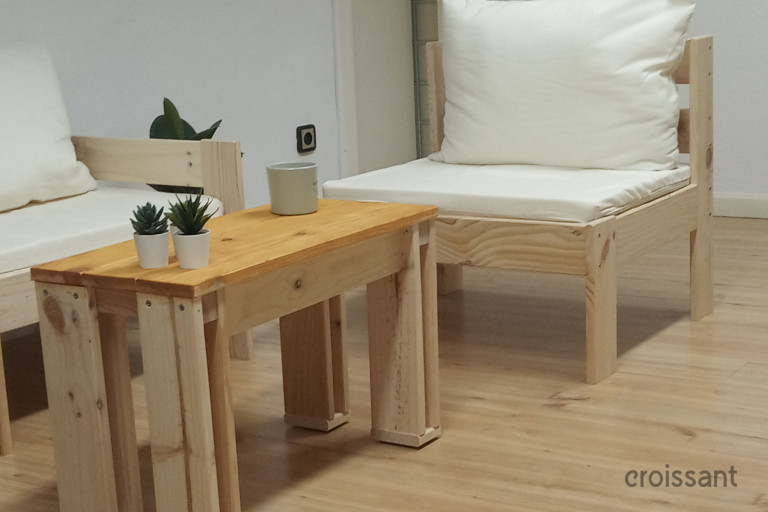 a bedroom with a bed and desk in a room