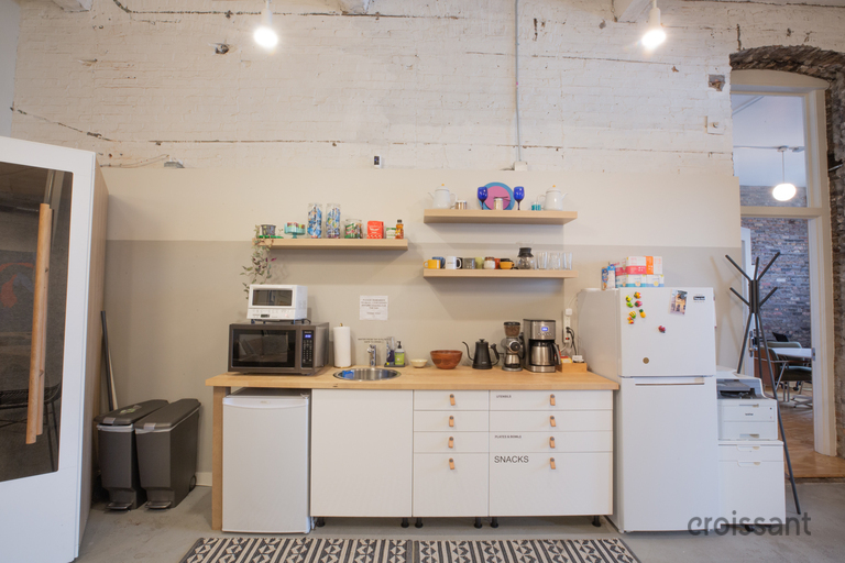a kitchen with a stove top oven sitting inside of a room