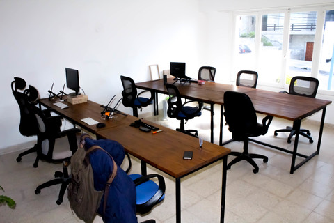 a desk with a computer and a chair in a room