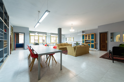 a living room filled with furniture next to a building