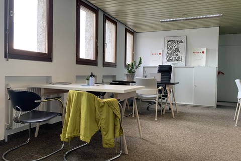 a room filled with furniture and a large window