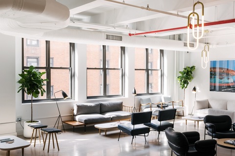 a living room filled with furniture and a large window