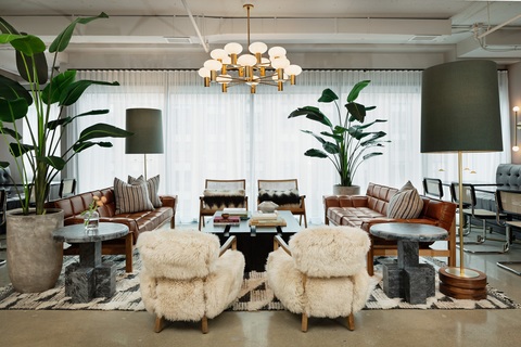 a living room filled with furniture and vase of flowers on a table