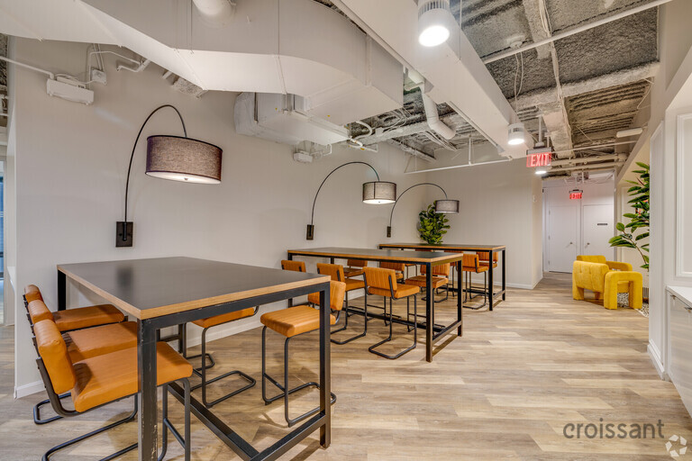 a kitchen with a table and chairs in a room