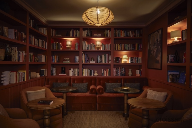 a room filled with furniture and a book shelf