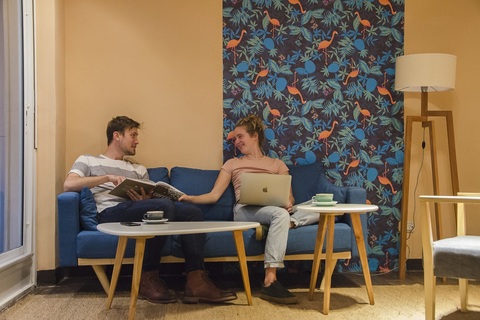 a man sitting in a chair using a laptop