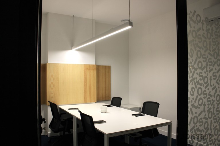 a bedroom with a bed and desk in a room