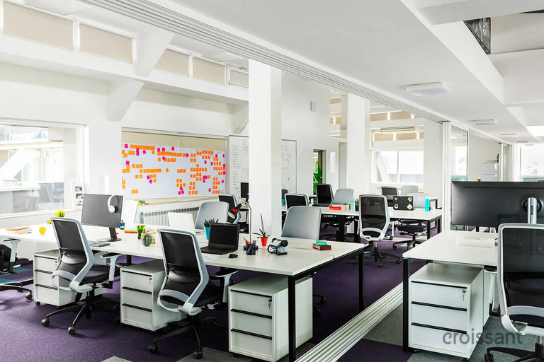 an office with a desk and chair in a room
