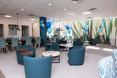 a room filled with furniture and a blue chair
