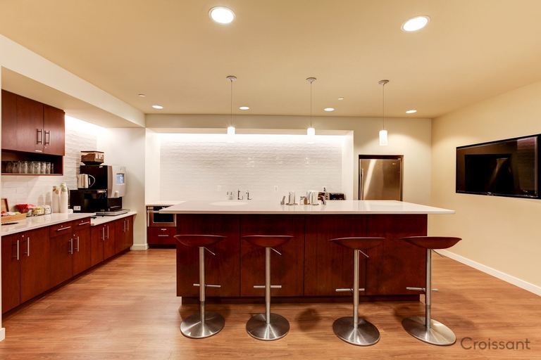 a modern kitchen with an island in the middle of a room