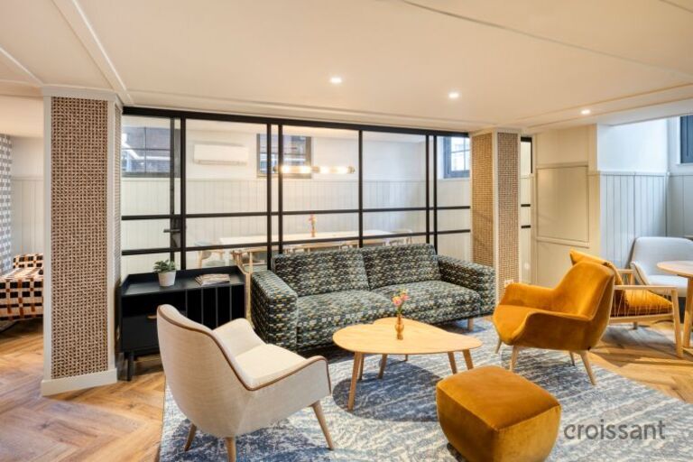 a living room filled with furniture and a large window