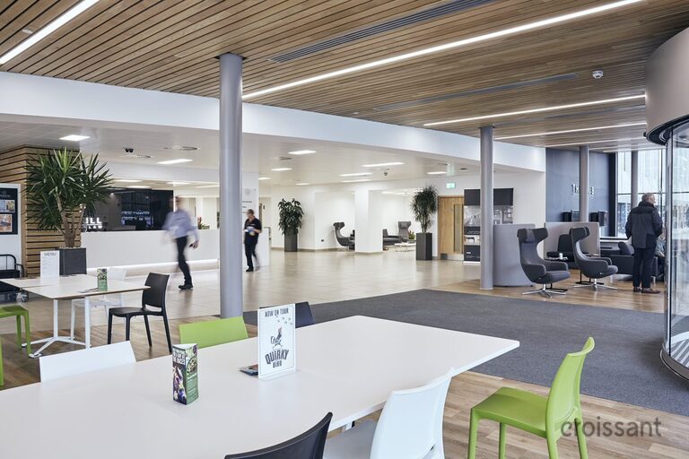 a living room filled with furniture and a large window