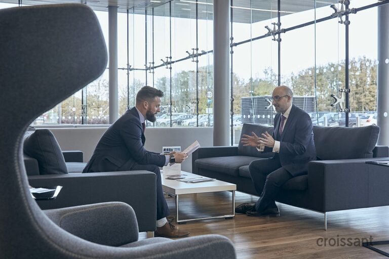 a person sitting on a chair in front of a window