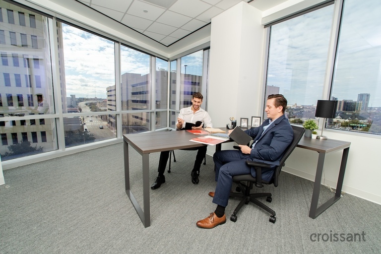 a person sitting in a chair in front of a window
