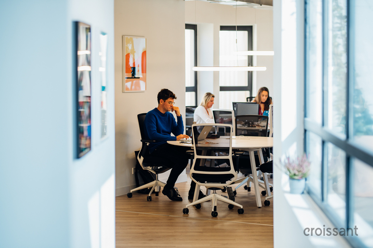a man sitting in front of a laptop computer
