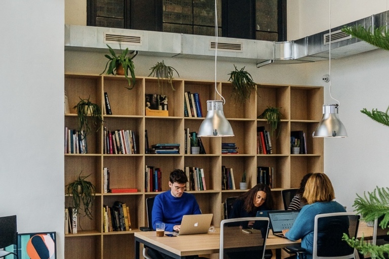 a person sitting at a desk in front of a window