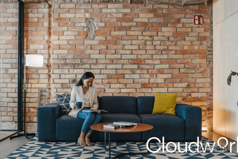 a person sitting in a living room with a brick wall