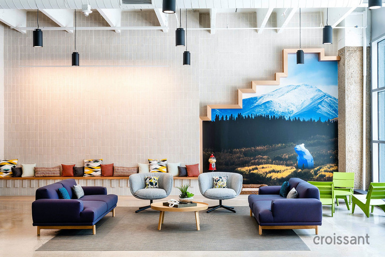 a room with a couch and table in front of a building