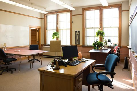 a living room filled with furniture and a large window