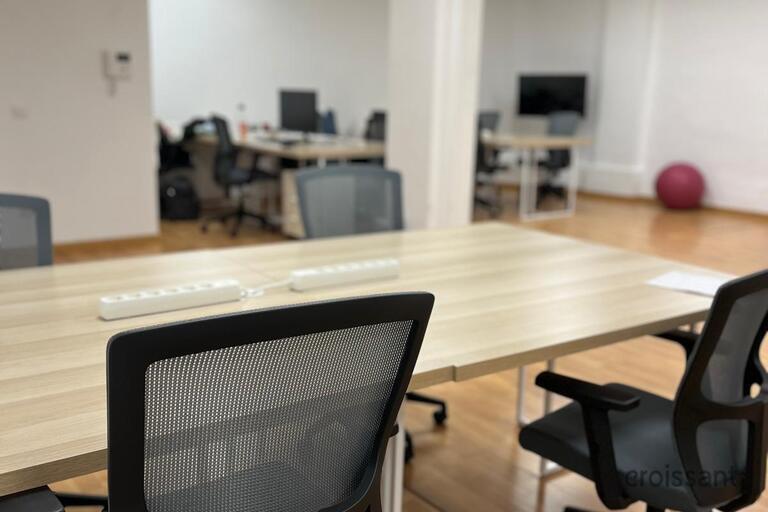 an office with a desk and chair in a room