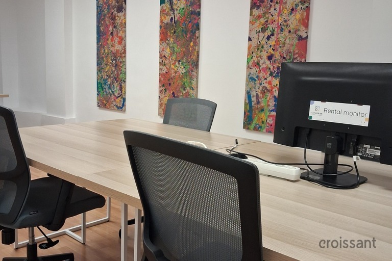 a living room with a desk and chair