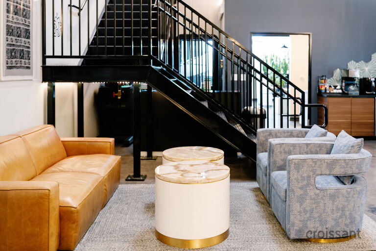 a living room filled with furniture and a large window