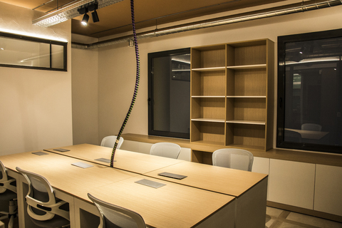 a bedroom with a bed and desk in a room