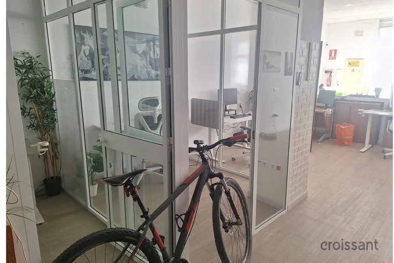 a bicycle leaning against a glass wall