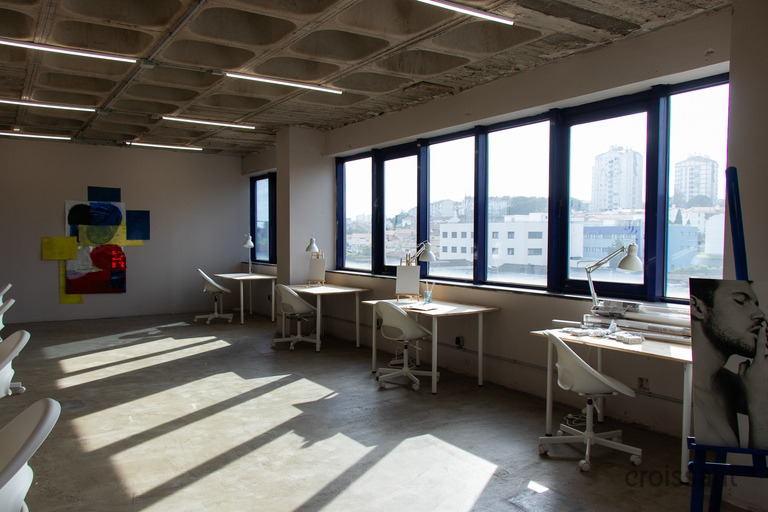 a room filled with furniture and a large window