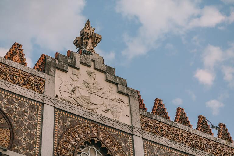 a large tall tower with a clock on the side of a building