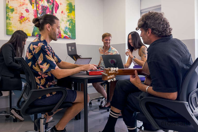 a group of people sitting at desks in a room