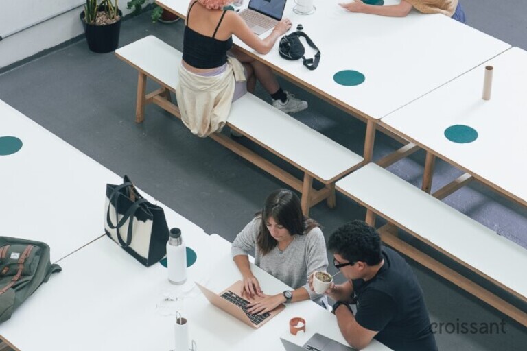 a group of people sitting at a desk