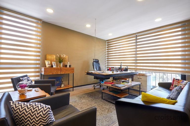 a living room filled with furniture and a large window