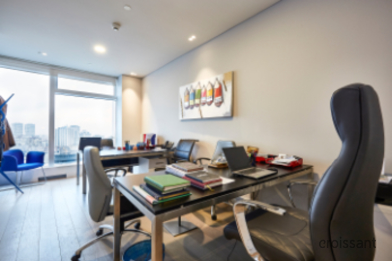 an office with a desk and chair in a room