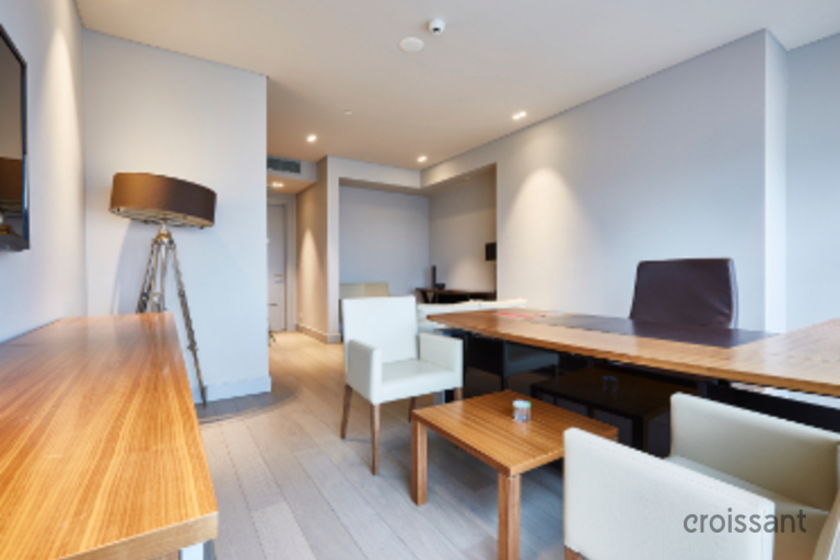 a living room filled with furniture on top of a hard wood floor