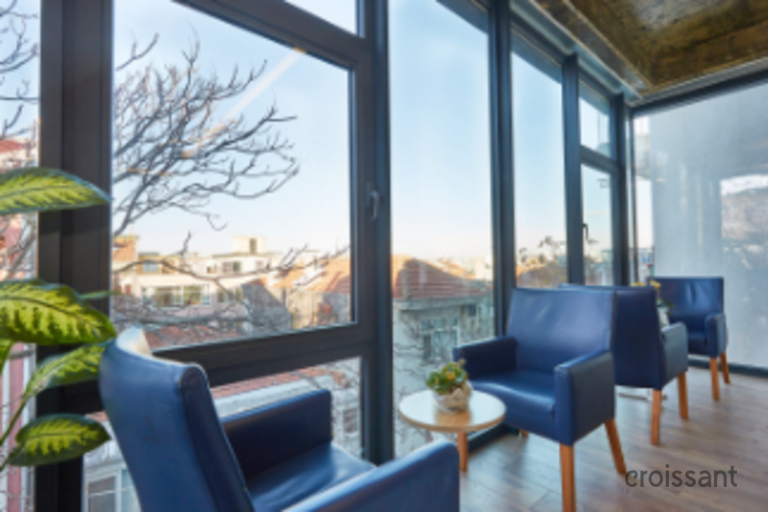 a living room filled with furniture and a large window