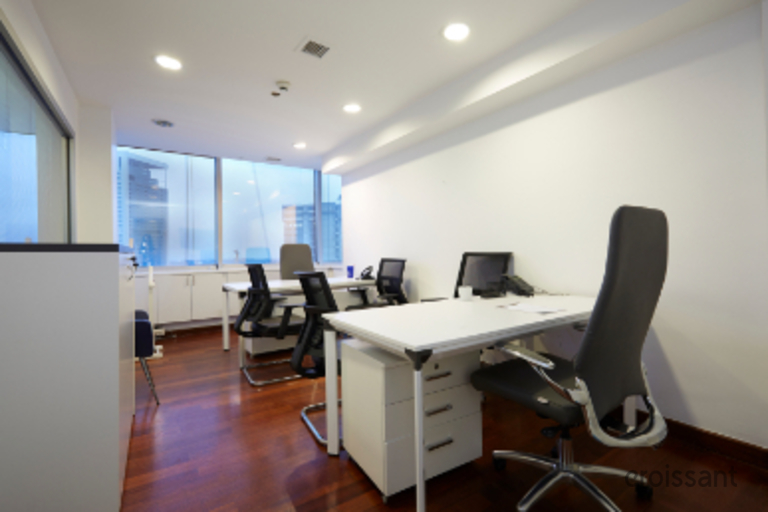 an office with a desk and chair in a room