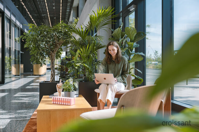 a person sitting at a table in front of a window