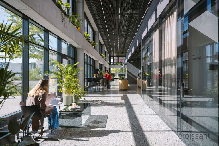 a person sitting on a bench in front of a building