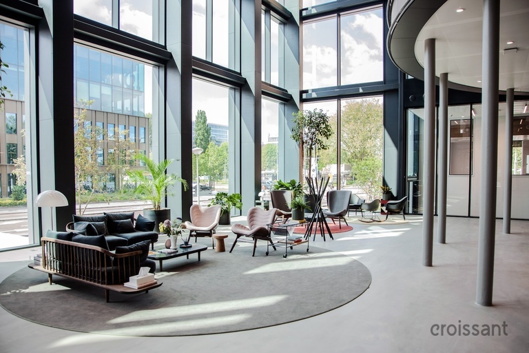 a living room filled with furniture and a large window