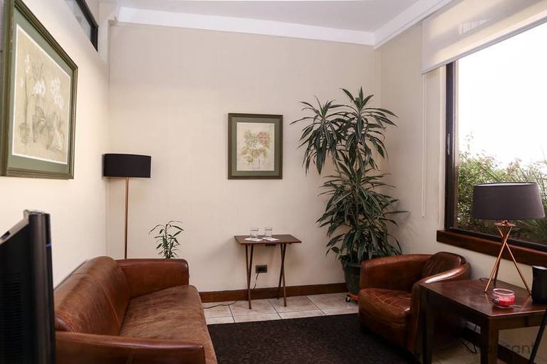 a living room filled with furniture and a flat screen tv
