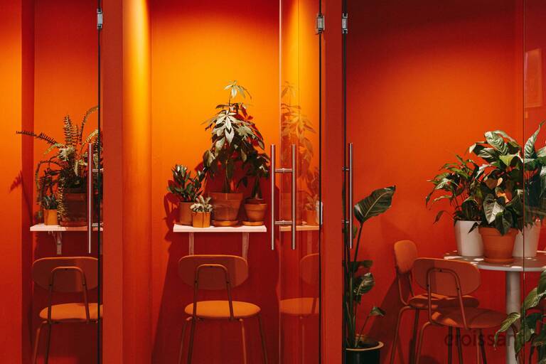 a room filled with furniture and vase of flowers on a table