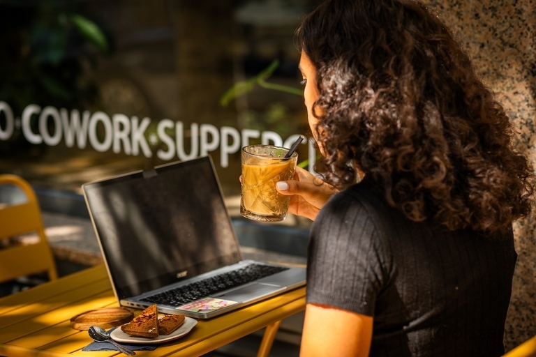 a man standing in front of a laptop