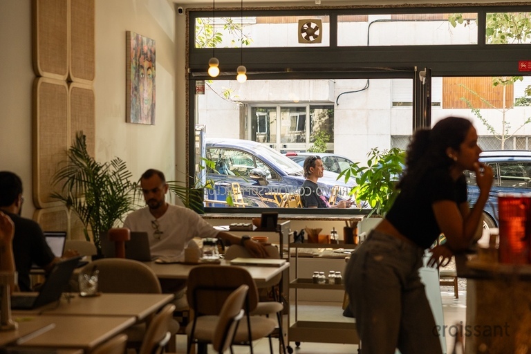 a group of people sitting at a table in front of a window
