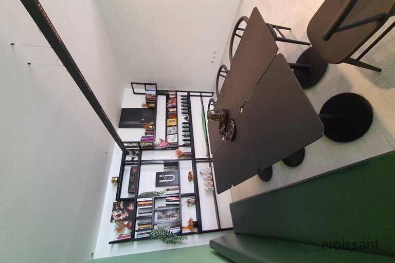 a desk with a computer and a chair in a room